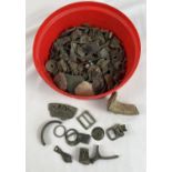 A tub of metal detector finds. To include buckles, coins and cow parts of cow bells.