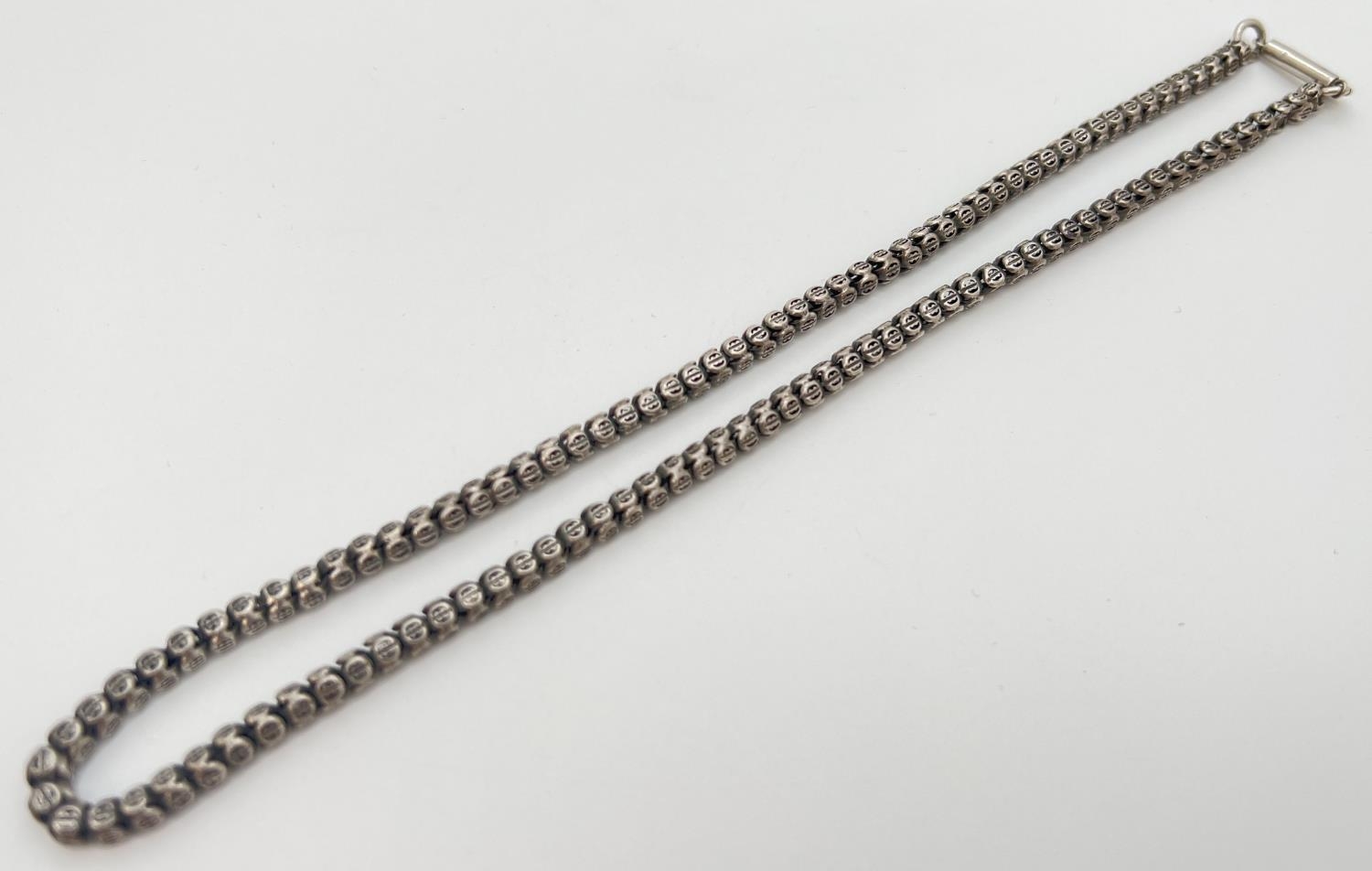 A 17 inch white metal bead chain necklace with pierced detail and barrel push clasp. - Image 2 of 3