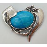 An Art Nouveau style 950 silver brooch set with a large turquoise colour ceramic panel. Approx. 5.