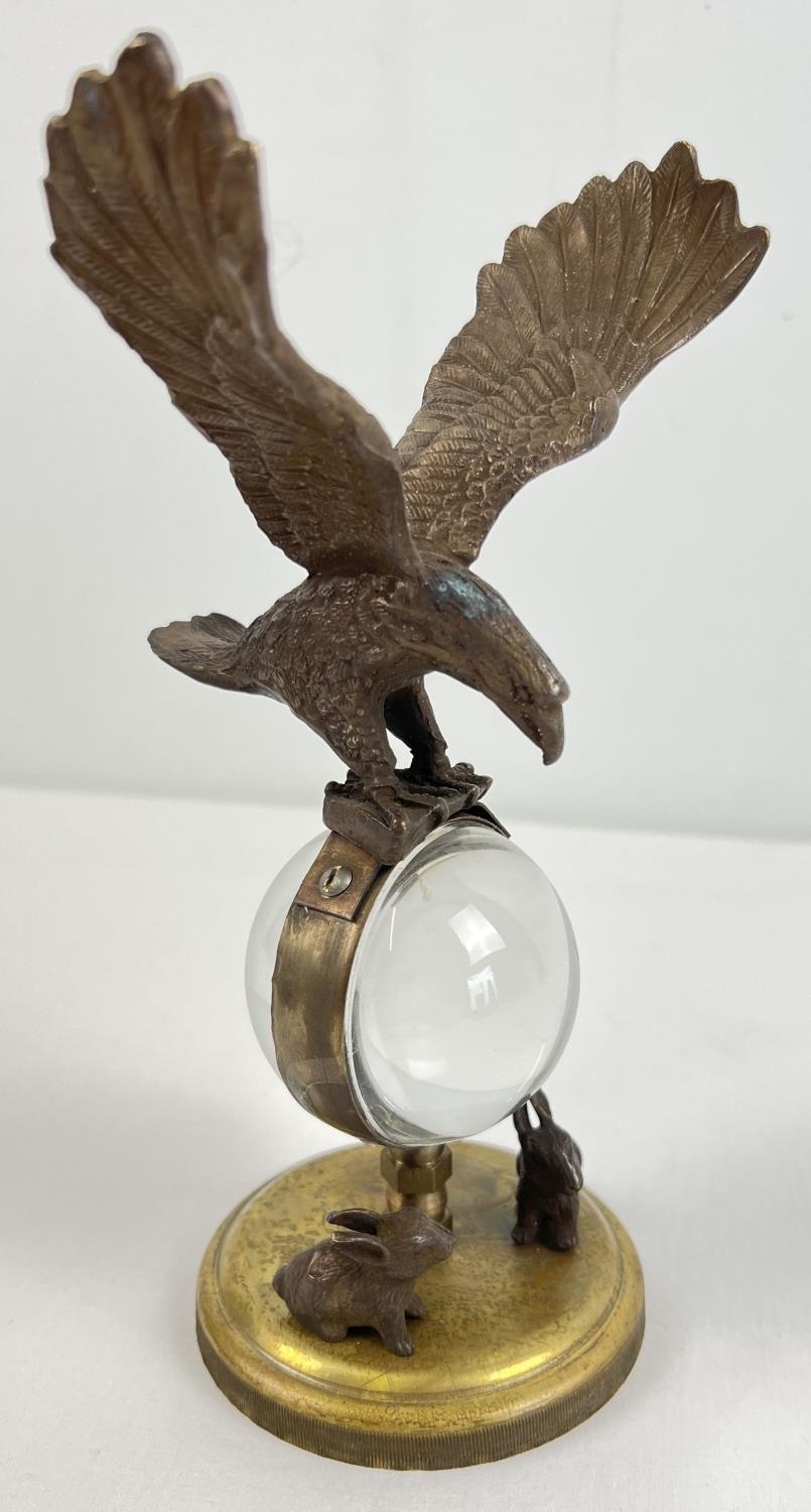 An ornamental brass ball clock with eagle shaped finial and rabbit figures to base. With wind up - Image 2 of 3