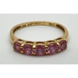 A 14ct gold half eternity ring set with 5 round cut pale pink Diamonique cubic zirconia stones. Size
