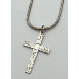 A vintage silver cross pendant with floral decoration to front on an 18" snake chain with lobster