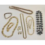 A collection of vintage gold tone and metallic tone jewellery. To include a Greek key matching