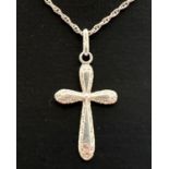 A vintage small silver cross shaped pendant with engraved detail to edges. On an 18" fine rope chain