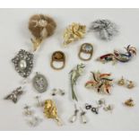A collection of vintage brooches and and costume jewellery earrings. To include stone set and faux