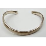 A modern design curved silver cuff bangle. Marked 925 to inside.