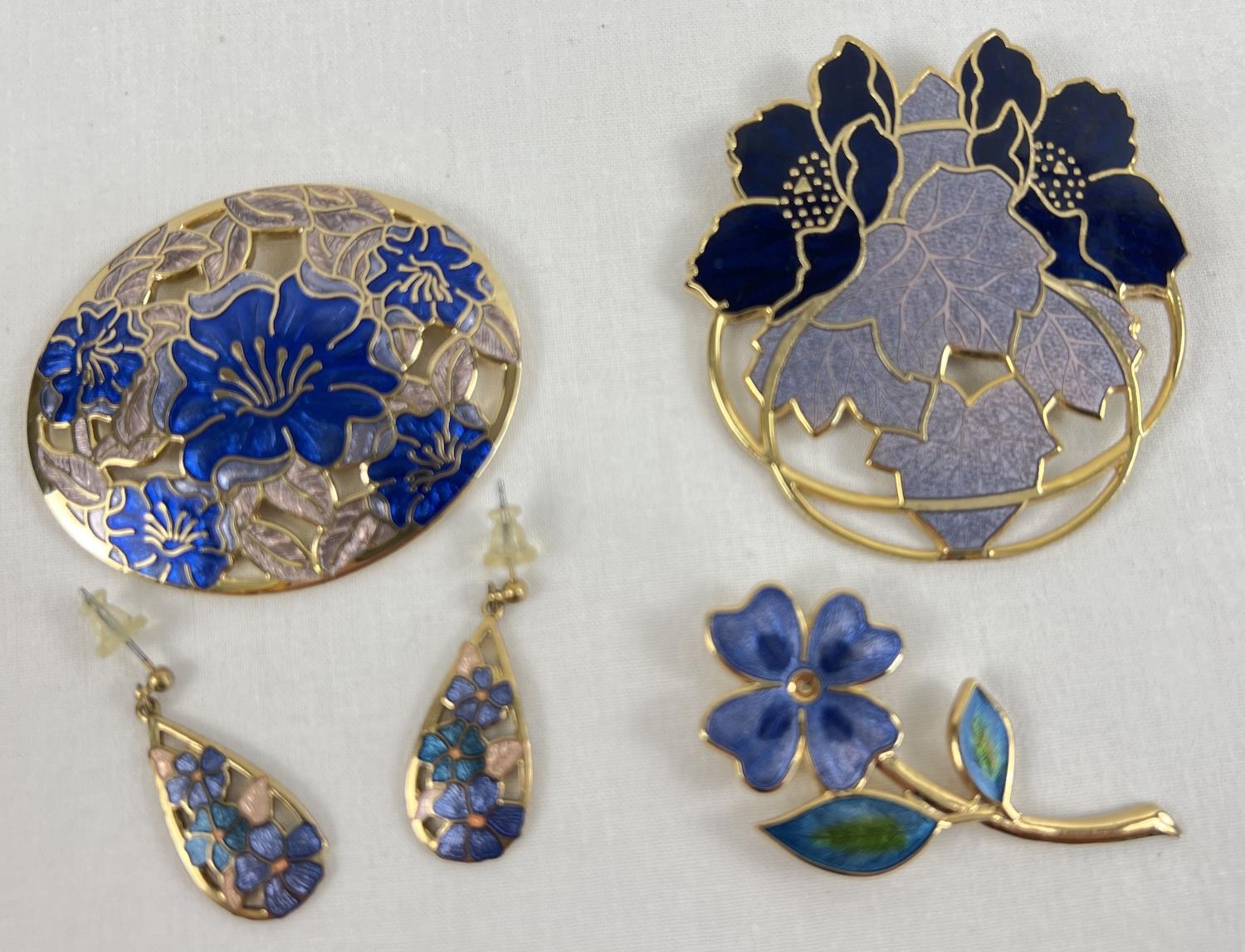 A small collection of Fish & Crown enamelled jewellery. A large circular floral brooch, a flower