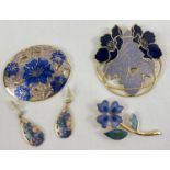 A small collection of Fish & Crown enamelled jewellery. A large circular floral brooch, a flower