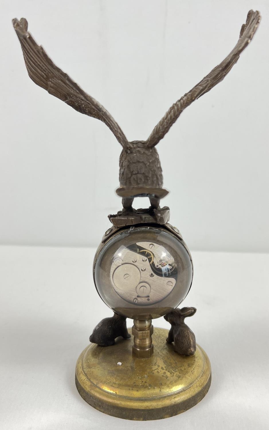 An ornamental brass ball clock with eagle shaped finial and rabbit figures to base. With wind up - Image 3 of 3
