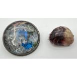 2 silver vintage brooches. A silver backed brooch with foiled back dome glass panel depicting a