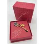A boxed Art 9446 930 001 Crystal Rose brooch by D. Swarovski & Co. Gold tone stem and leaves with