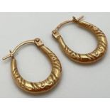 A pair of 9ct gold creole style earrings with hinged posts. Approx. 1.5cm drops and 0.5g total