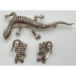 A vintage silver marcasite set lizard brooch with matching clip on earrings. Both marked 835 to