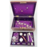 A Victorian jewellery box containing assorted vintage silver, jewellery and watches. Purple fabric