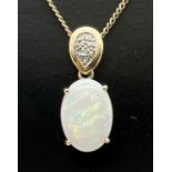 A hallmarked 9ct gold and opal pendant set with 5 small diamonds. On an 18.5" 9ct gold curb chain