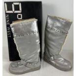 A boxed pair of soft silver leather moccasin style "Melyn" knee length boots with faux fur lining by