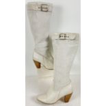 A pair of vintage style soft white leather heeled boots with buckle detail to top. Size 6.