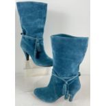 A pair of teal suede, pull on calf length heeled boots with wrap and tassel detail. Size 40.