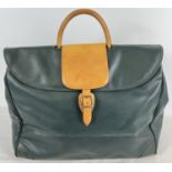 A vintage dark green faux leather "Perrier" hold all/ weekend bag with tan leather handle.