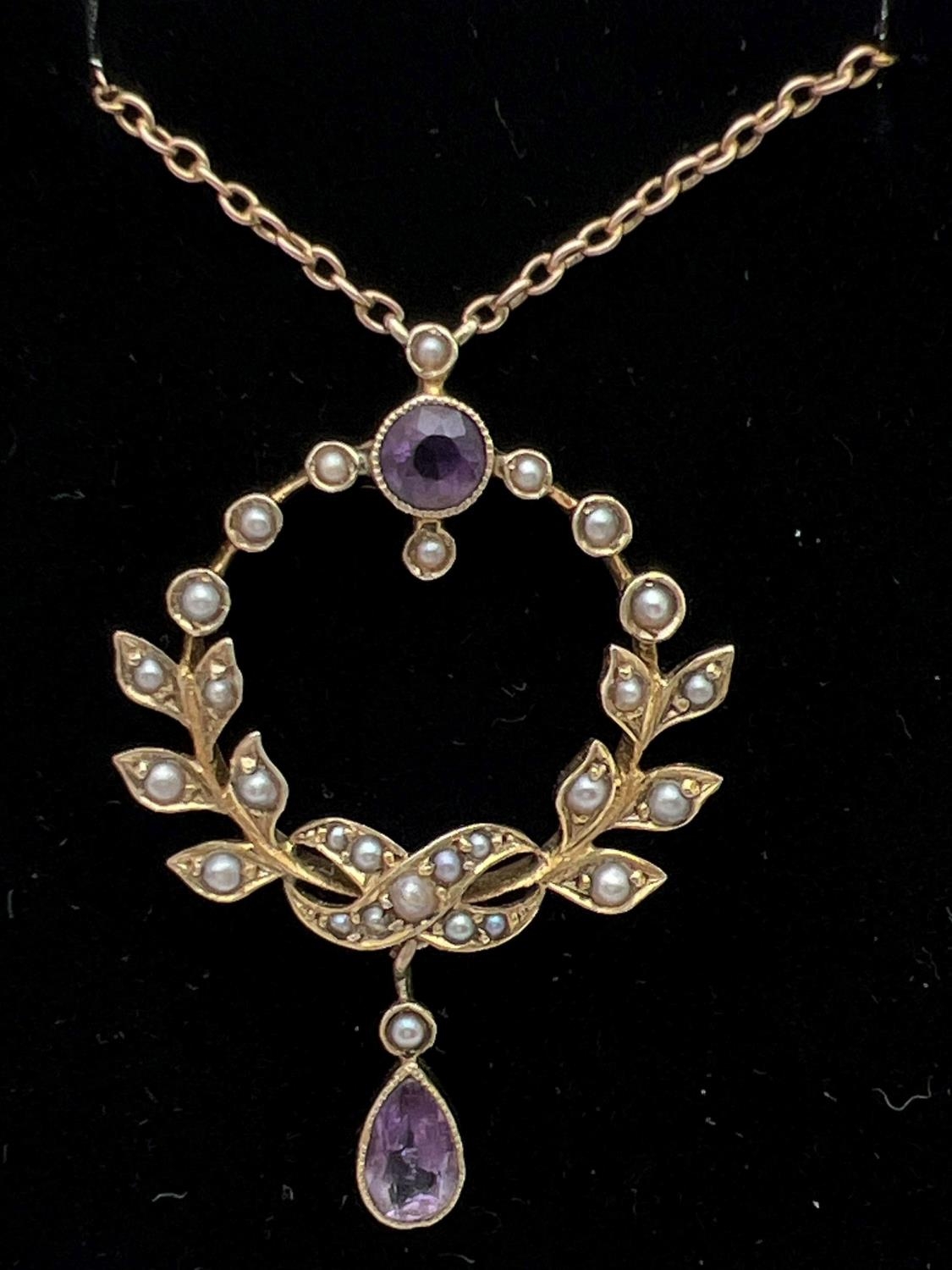 An Art Nouveau 9ct gold necklace set with amethysts and seed pearls, in original silk and velvet