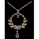 An Art Nouveau 9ct gold necklace set with amethysts and seed pearls, in original silk and velvet