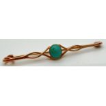 A 15ct gold twist design bar brooch set with a central turquoise cabochon. Marked 15ct to back