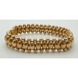 A 14ct gold oval and round bead elasticated bracelet, approx. 7 inches long. Total weight approx.