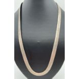 A silver 24 inch large herringbone style silver necklace with lobster claw clasp. Silver marks to
