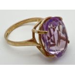 A 9ct gold cocktail ring set with a large oval cut Rose de France amethyst. Stone approx. 16mm x