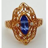 An 18ct gold, Ceylon sapphire ring with pierced work decorative mount. Set with a marquise cut