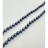 An 18" string of knotted blue pearls with pierced work 14/20 gold filled fishhook clasp.