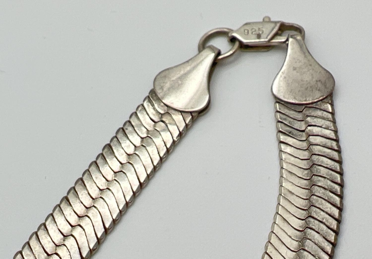 A silver 24 inch large herringbone style silver necklace with lobster claw clasp. Silver marks to - Image 3 of 3