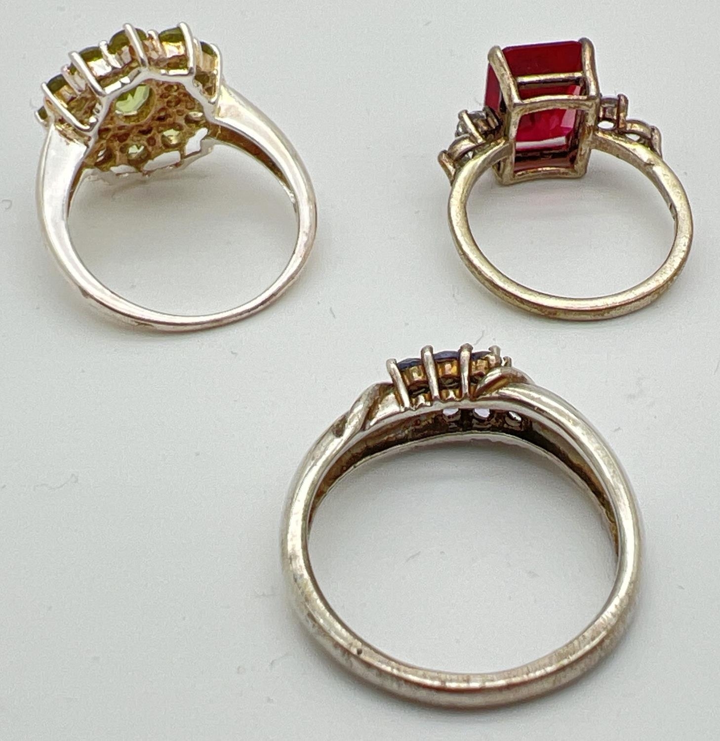 3 silver stone set dress/cocktail rings. A square cut red spinel with two round cut clear stones - Image 3 of 3