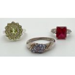 3 silver stone set dress/cocktail rings. A square cut red spinel with two round cut clear stones