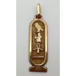 A 9ct gold hieroglyph pendant with hanging bale. Gold marks to back and inside of bale. Total weight