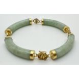 A 14ct gold and pale green jade bracelet. Long curved jade beads with capped ends and alternating