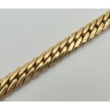 An 18ct gold Cuban link chain bracelet with lobster claw clasp. Approx. 8.5 inches long and 8 mm