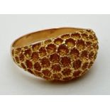 A vintage 18K gold dome style ring with honeycomb design to top. Gold mark to inside of band. Size