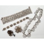 A small collection of vintage white metal jewellery. To include floral design brooches, a multi