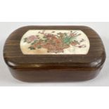 A small Japanese fruitwood wooden box, sliding lid has carved bone insert with floral decoration.