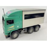 A 1:16 scale Volvo freezer style 6 wheeled lorry in green and grey, with opening doors to back, by