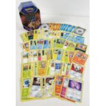 200 assorted PokÃ©mon cards in a Galar Legend Zacian PokÃ©mon V trading card game tin.