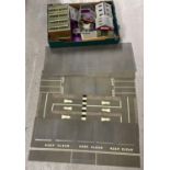 A collection of cardboard kit model railway/model vehicle buildings and road way sheets. To