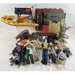 A large box of Action Man dolls, and accessories. To include: 4 dolls, bear, boat, clothes and