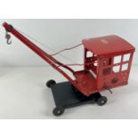 A vintage Triang red painted pressed steel large sized crane with hook. On original Triang rubber