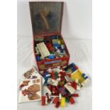 A vintage tin of assorted Lego pieces with instruction booklet.