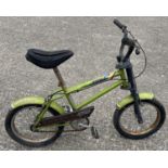 A vintage Raleigh "Stricka" children's bicycle in lime green with black seat, pedals and handlebars.