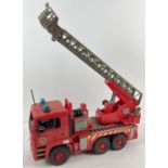 A 1:16th scale red hard plastic Man T6 410A fire engine by Bruder. With tipping and extending