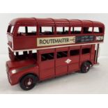 A modern red tin plate Routemaster double decker bus with decals to side. Approx 30 x 18cm.