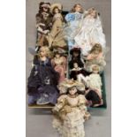 A collection of 14 large porcelain collectors dolls in period style dresses and hats. Some with